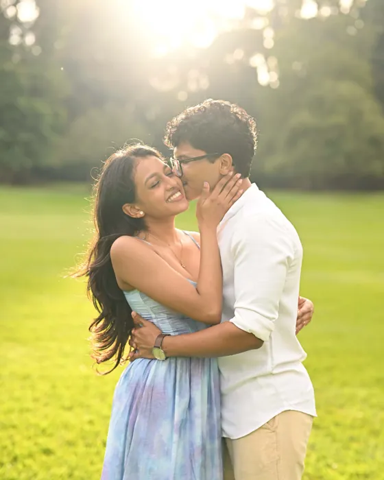 Nishara and Devon in a close embrace in golden morning light